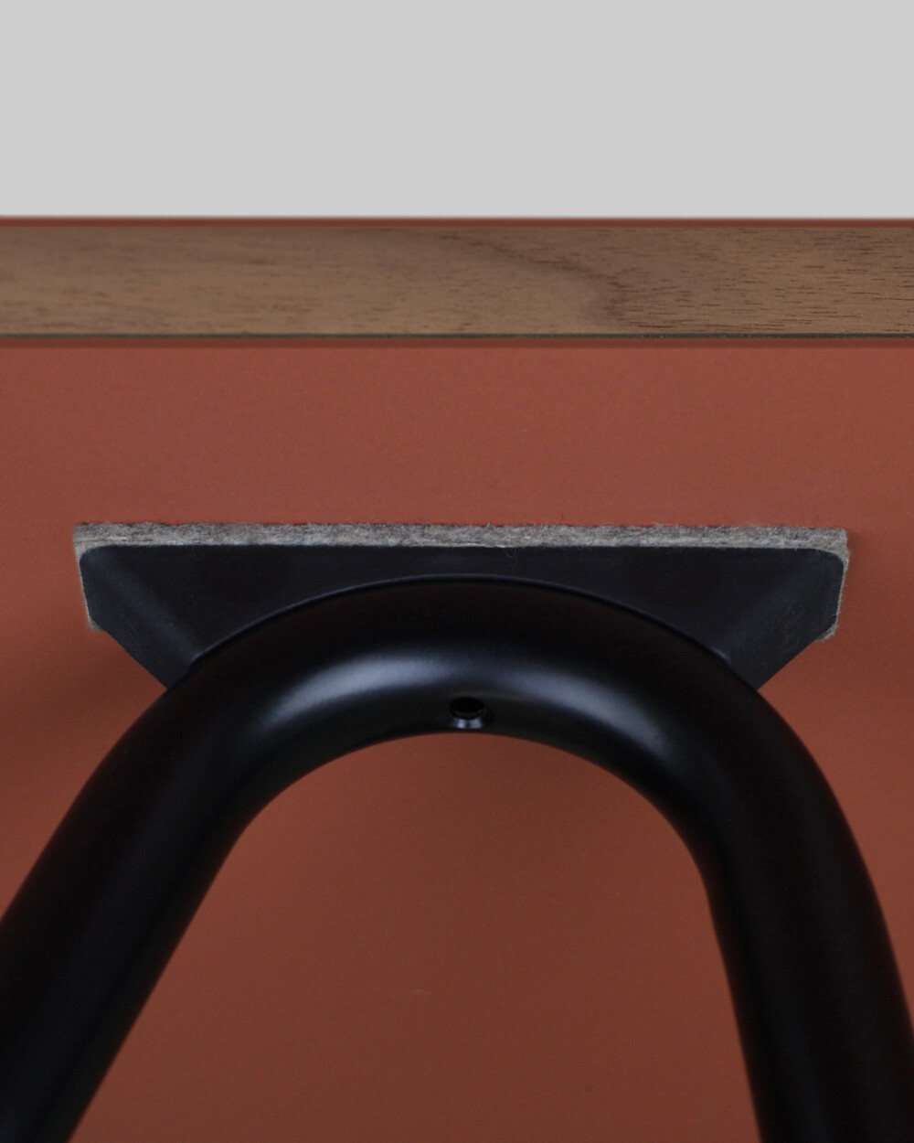 Detail of a Sinus Fix table trestle fixing from Faust, under a coated underside of a linoleum tabletop with felt covering.