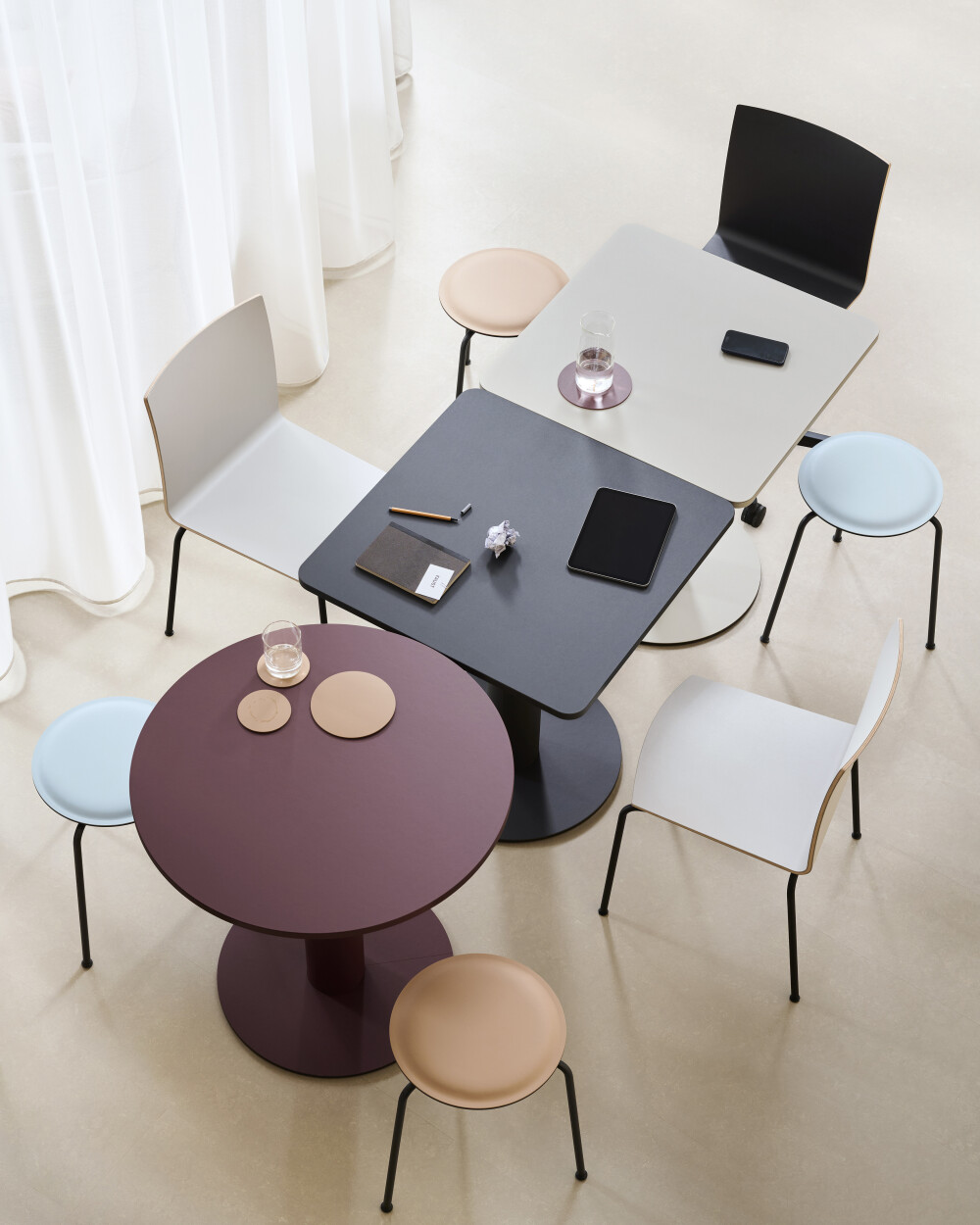 Round and square SPOT Bistro Tables arranged as modular workstations for informal meetings and collaborative office spaces.