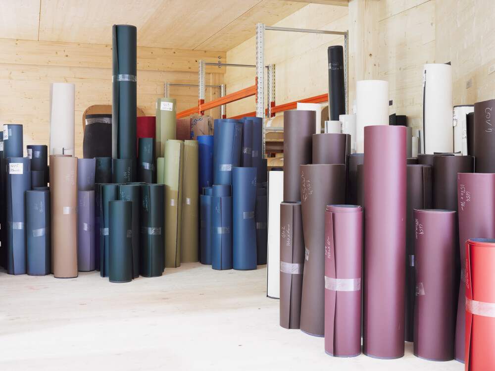 Interior of the Faust Linoleum production facility in Huglfing, Germany, showing a group of linoleum rolls of different colour variations