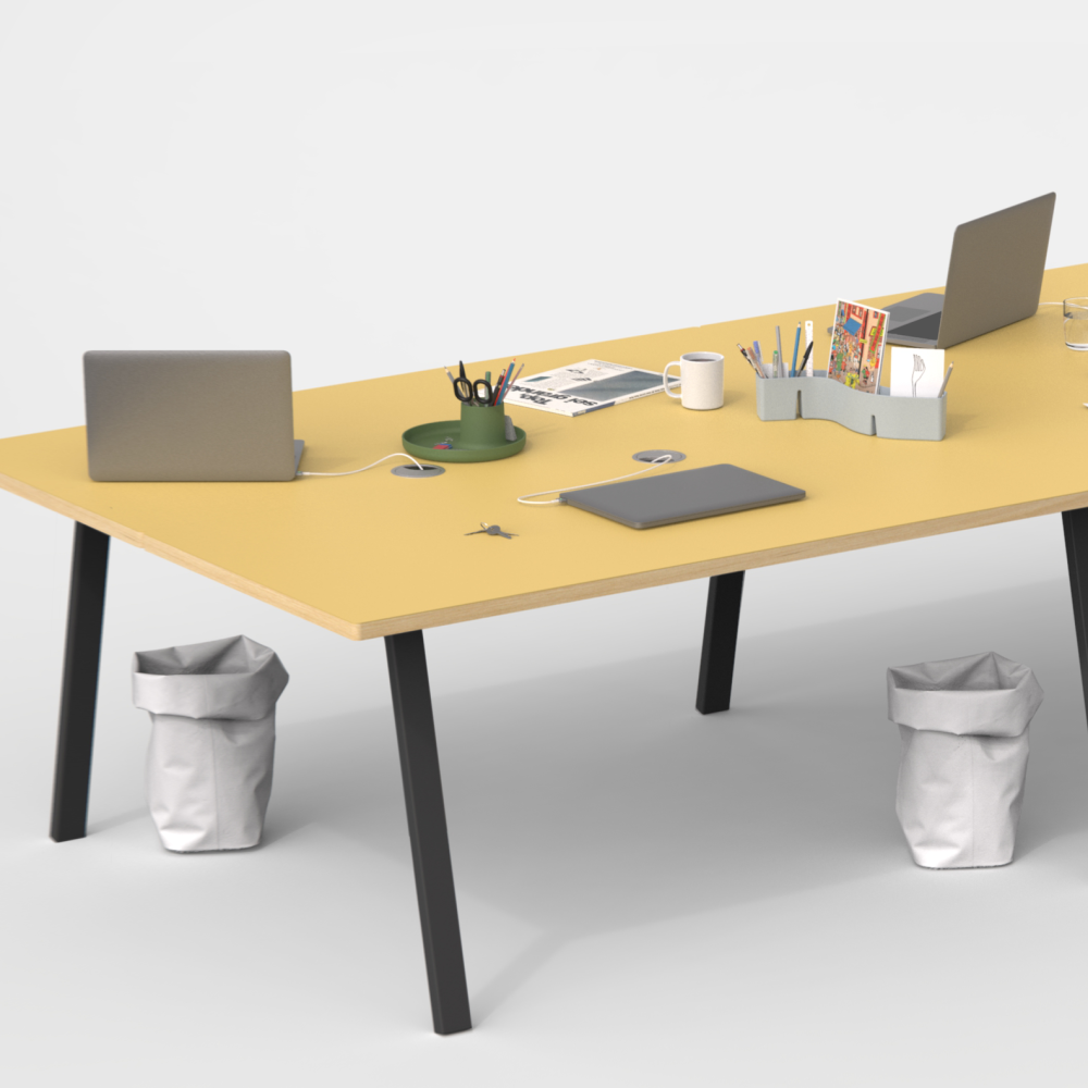 A spacious tabletop in Pure Linoleum with a wooden edge, supported by angled black metal DIN legs designed by Michel Charlot. It accommodates four workstations, equipped with cable management and featuring essential office items, creating an organised and