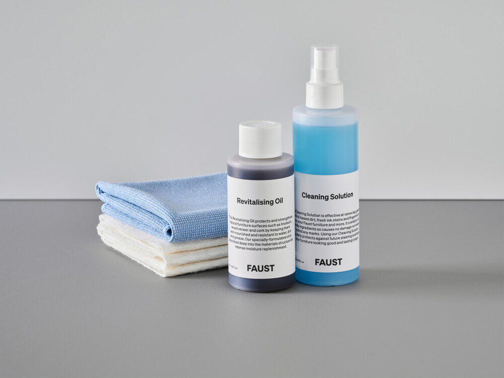 Cleaning and care kit from Faust for linoleum and wood veneer surfaces, including a bottle of revitalising oil, a cleaner, and soft cloths.
