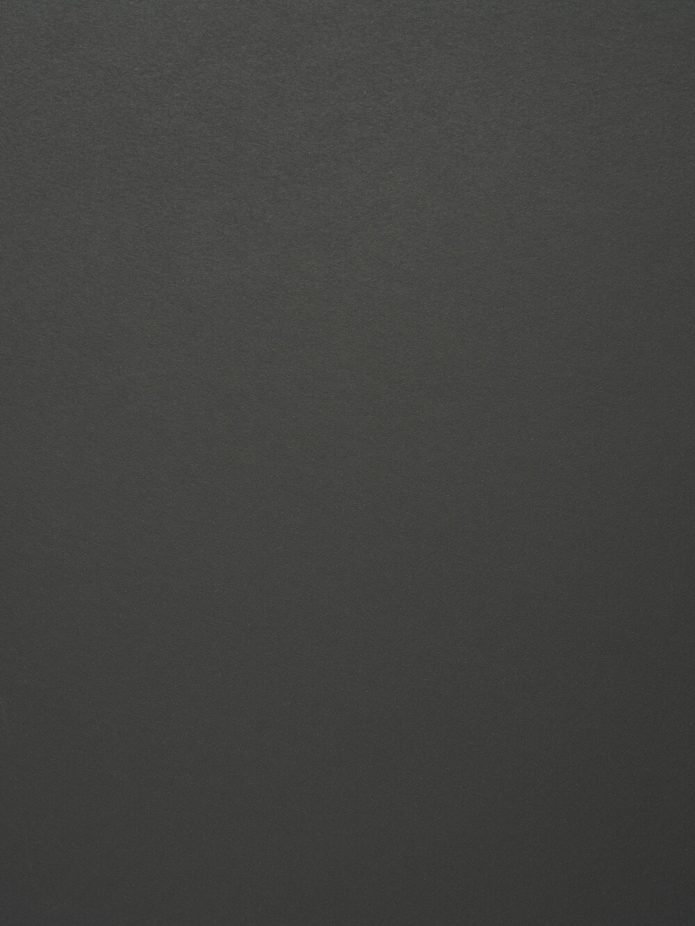 Nahaufnahme der Linoleum-Oberfläche in Charcoal – dunkler Anthrazitton, matt und fein strukturiert, wie bei Faust-Tischplatten eingesetzt.