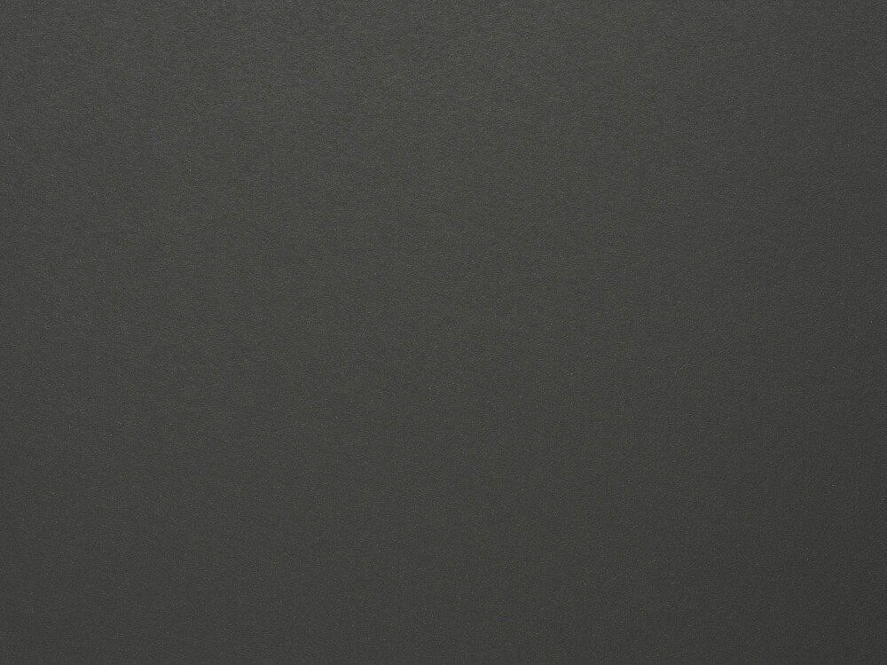 Nahaufnahme der Linoleum-Oberfläche in Charcoal – dunkler Anthrazitton, matt und fein strukturiert, wie bei Faust-Tischplatten eingesetzt.
