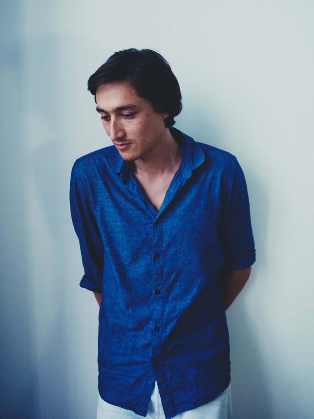 Portrait of Daniel Lorch - Berlin industrial designer and long-standing cooperation partner of Faust, photographed in the studio against a light background.
