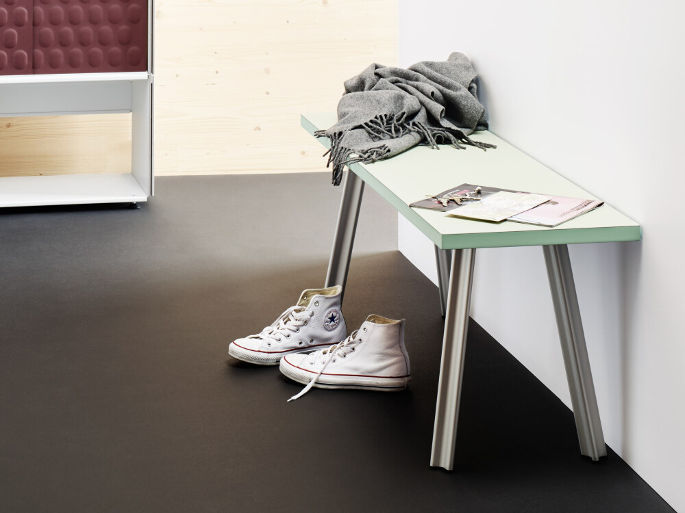 Hallway scene with BEAM bench in pistachio linoleum colour, combined with a sideboard and accessories such as shoes, scarf and plants.