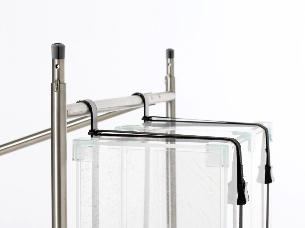 PC holder made of powder-coated steel, mounted on the E2 table frame for hanging a computer case under the tabletop.